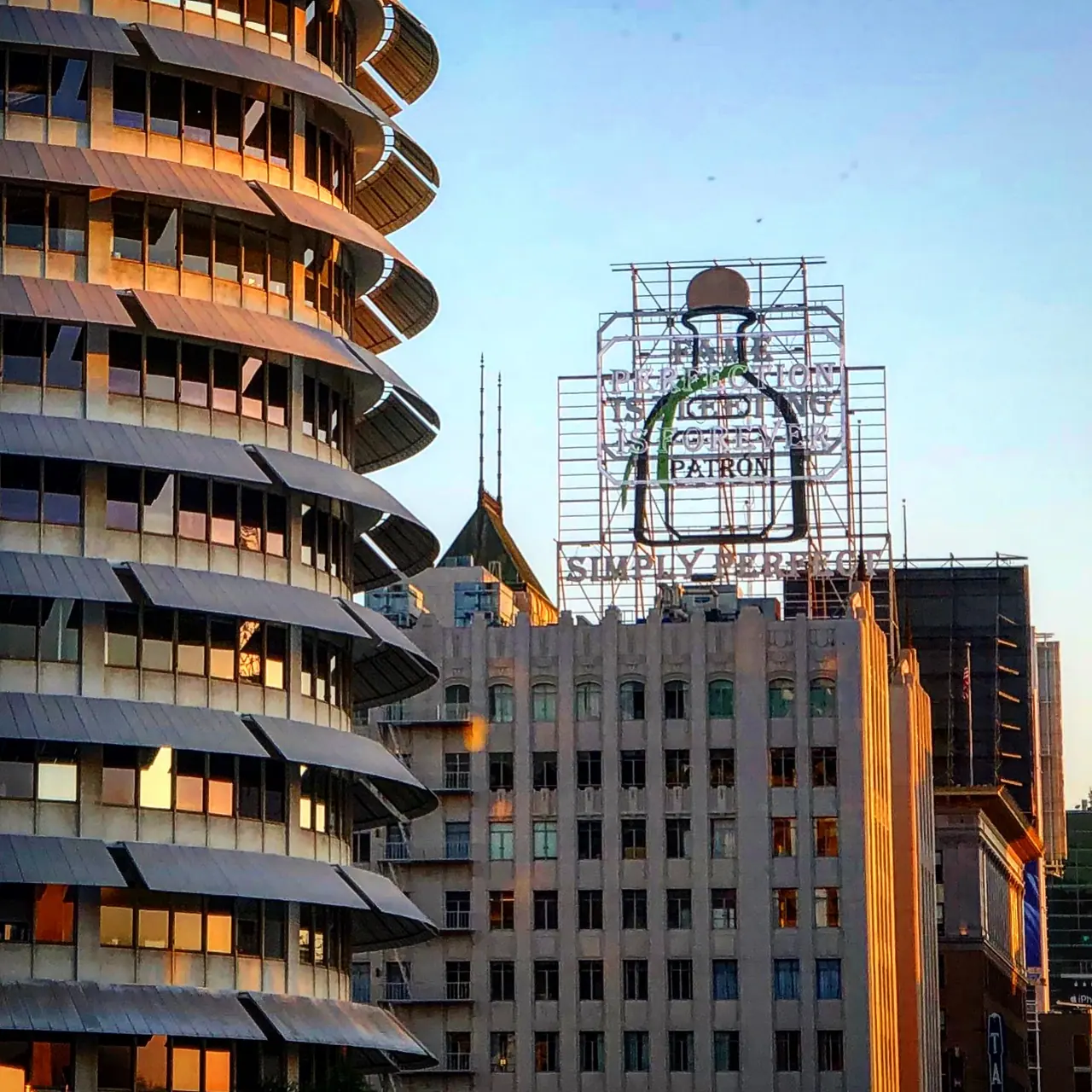 The curved Capitol Records building beside a rooftop billboard.