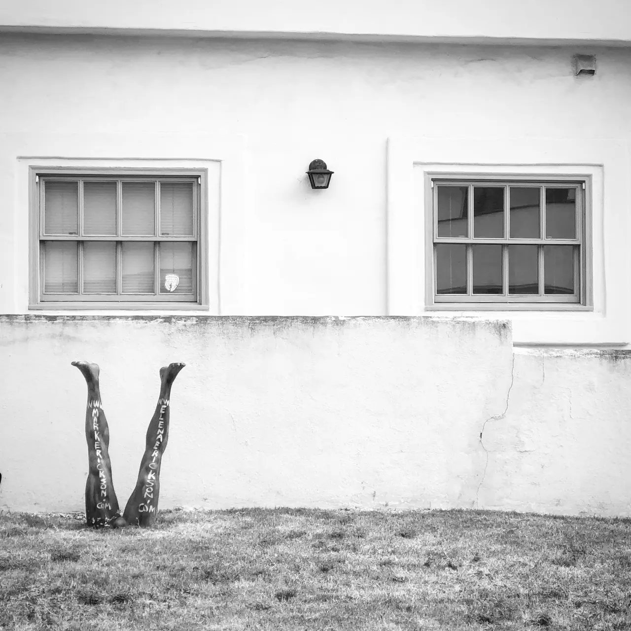 A pair of painted legs beneath windows in Venice.