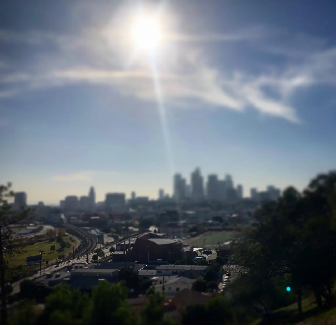 Sun glare above the Los Angeles skyline.