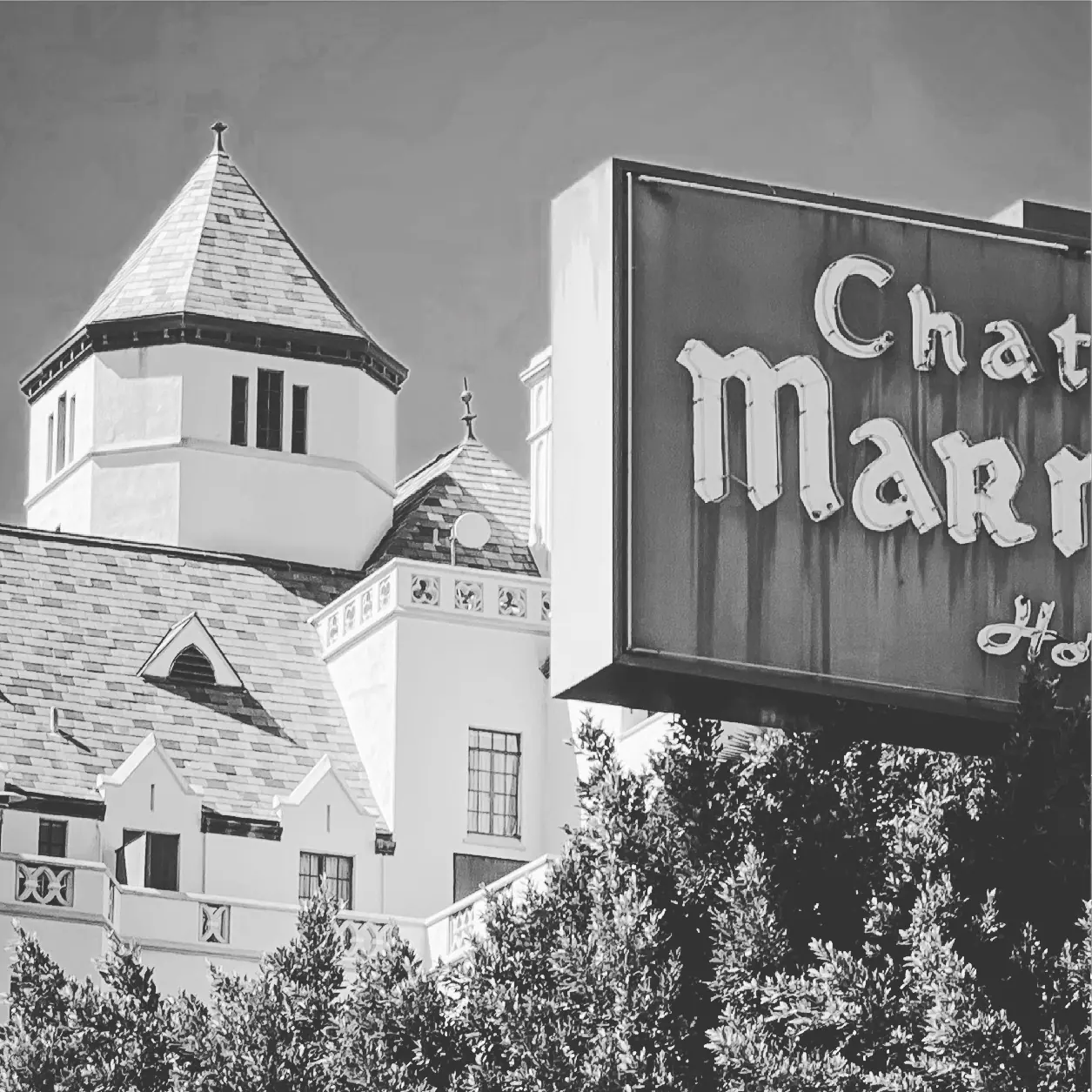 The Chateau Marmont sign and tower in black and white.