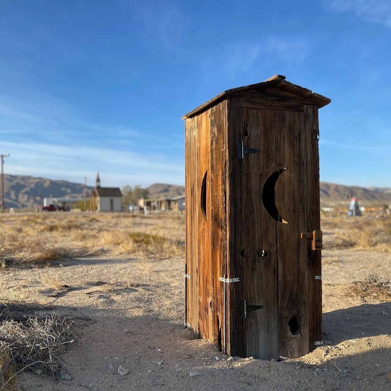 A wooden outhouse in the Joshua Tree desert.