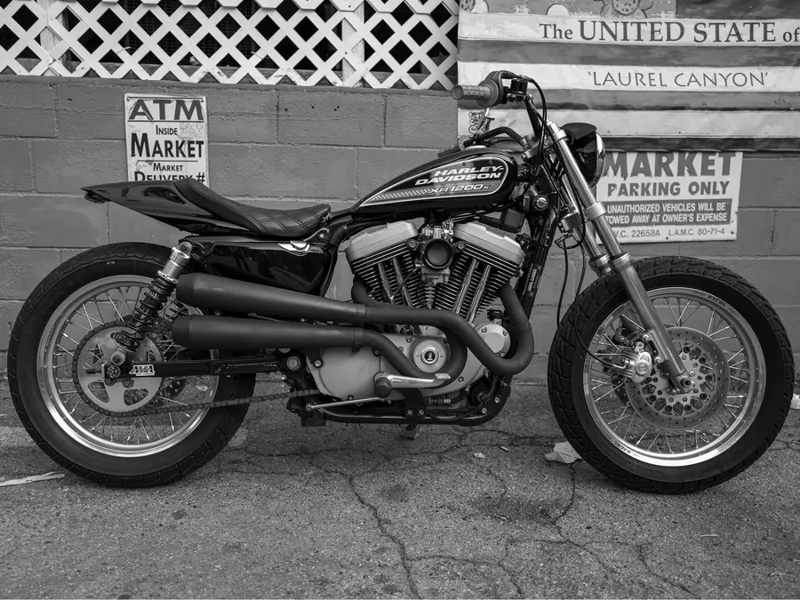 A motorcycle parked outside the Laurel Canyon market.