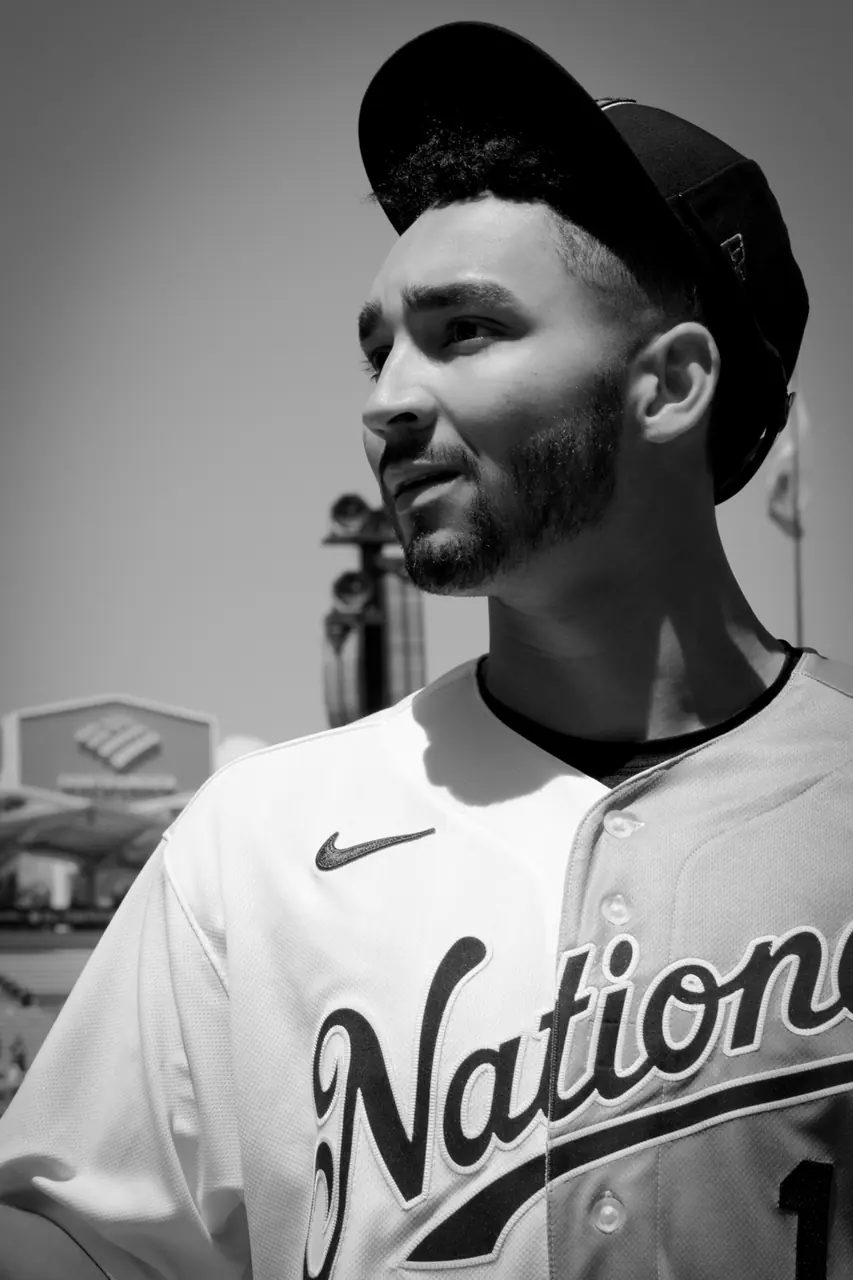 A close portrait of a baseball prospect beside the field.