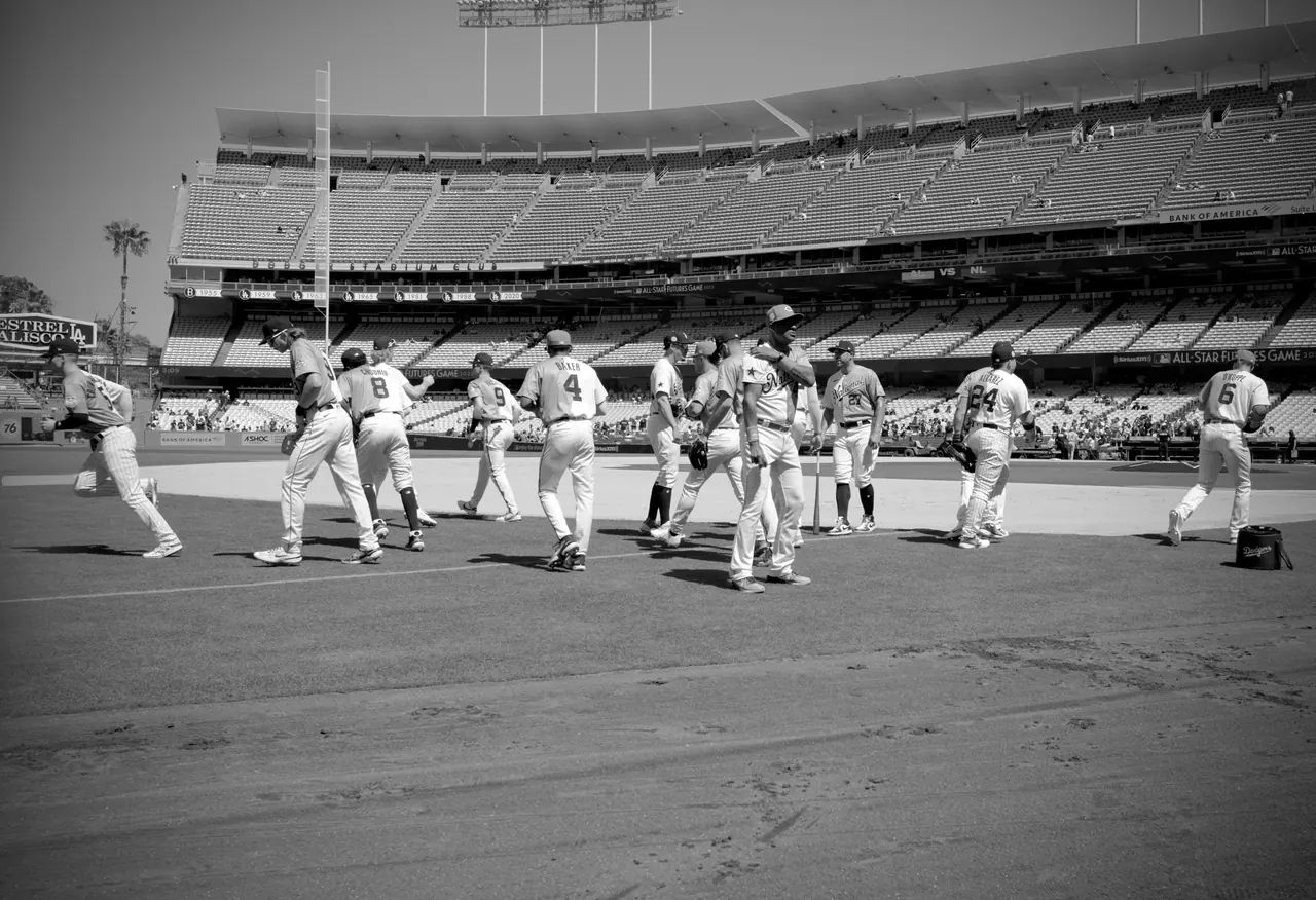 Baseball players gathering on the grass before a game.