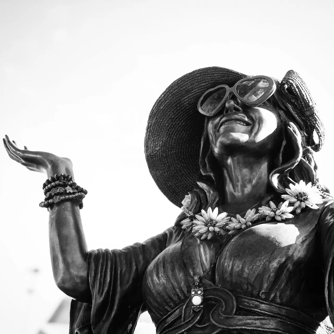 A bronze figure wearing a broad hat and sunglasses at Hollywood Forever Cemetery.